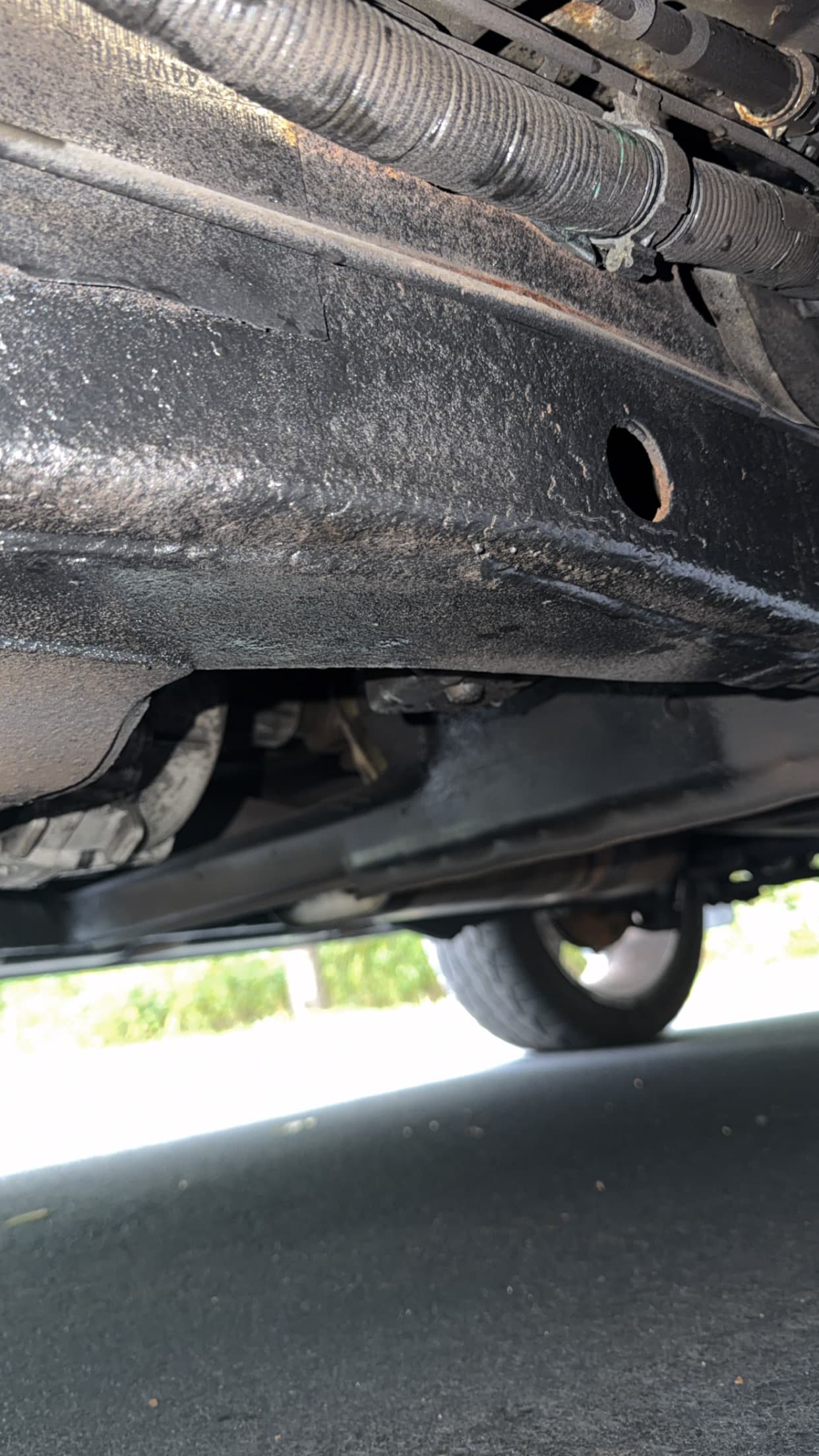 Corrosion visible on a vehicle underbody during a rust repair inspection